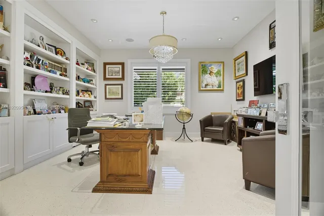 a front view of a house with swimming pool garden and patio