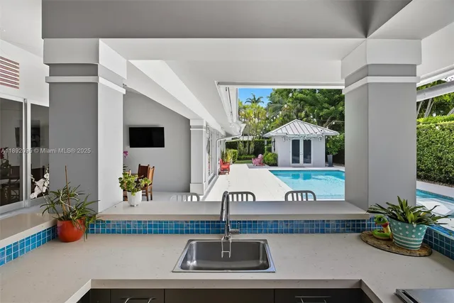an aerial view of residential house with outdoor space and trees all around