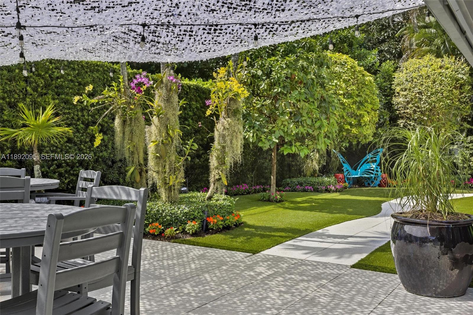 5800 Southwest 99th Terrace Pinecrest, FL 33156 - Photo 51 of 62 a view of a garden with a bench in a garden