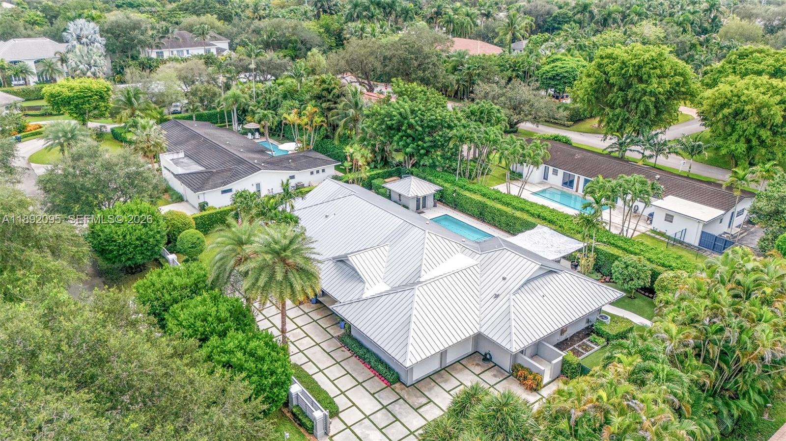 5800 Southwest 99th Terrace Pinecrest, FL 33156 - Photo 57 of 62 an aerial view of residential house with outdoor space and trees all around