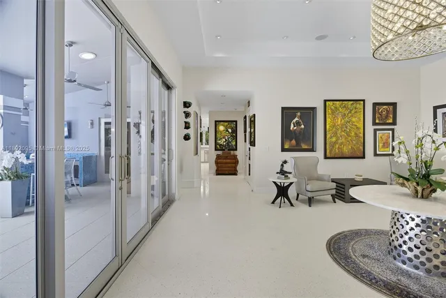 a kitchen with stainless steel appliances a refrigerator a stove a dining table and chairs with wooden floor