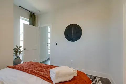 a bedroom with a bed and a potted plant