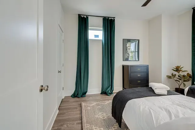 a bedroom with a bed and a potted plant