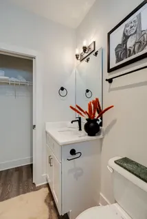 a bathroom with a sink a toilet and mirror