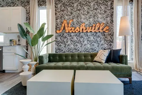 a living room with furniture and a potted plant