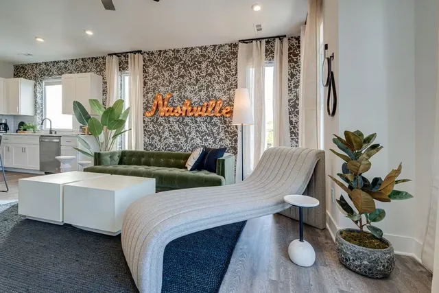 a living room with furniture and a potted plant