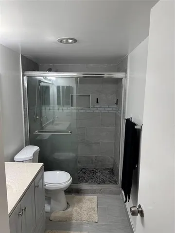 a bathroom with a toilet and a shower