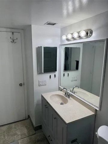 a bathroom with a sink double vanity and a mirror