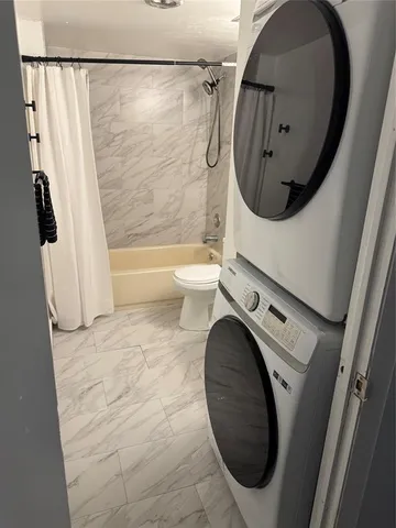 a bathroom with a toilet mirror and tub