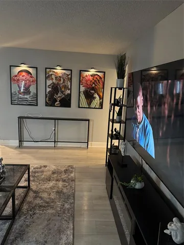 a living room with furniture a rug and a flat screen tv