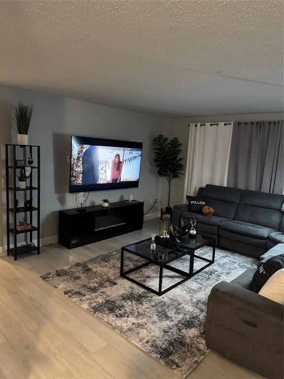 4174 Inverrary Drive, Unit 401 Lauderhill, FL 33319 - Photo 4 of 15 a living room with furniture and a flat screen tv