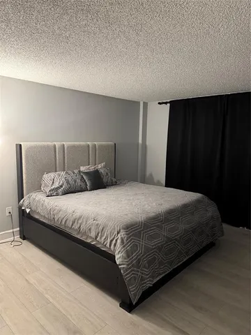 a large bed sitting in a bedroom next to a cabinet