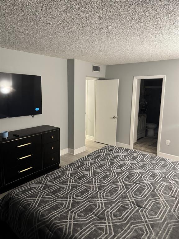 4174 Inverrary Drive, Unit 401 Lauderhill, FL 33319 - Photo 10 of 15 a bedroom with a bed and a television