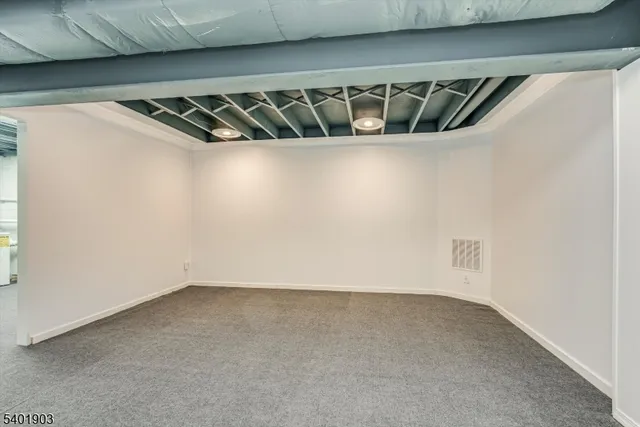 a living room with furniture and a kitchen view