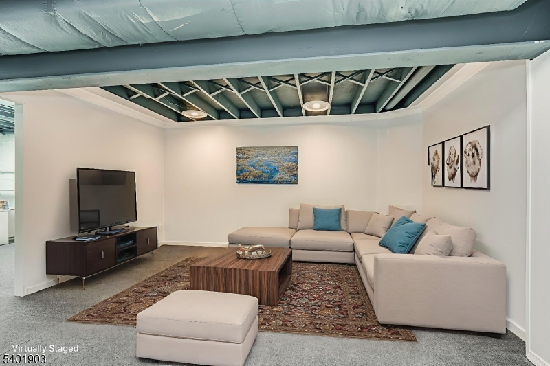 223 Cherokee Road Lafayette, NJ 07848 - Photo 28 of 36 a living room with furniture and a flat screen tv