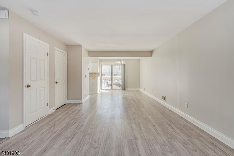 223 Cherokee Road Lafayette, NJ 07848 - Photo 5 of 36 a view of an empty room with wooden floor and a window