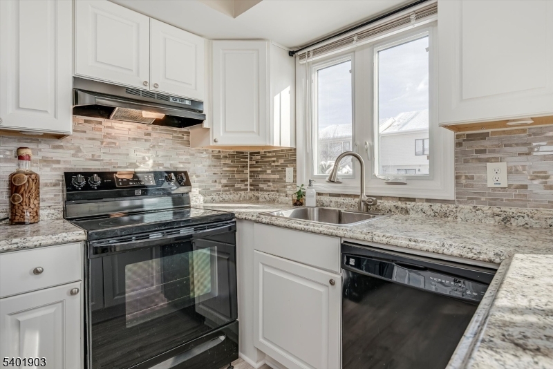 223 Cherokee Road Lafayette, NJ 07848 - Photo 10 of 36 a kitchen with stainless steel appliances granite countertop a sink stove and cabinets