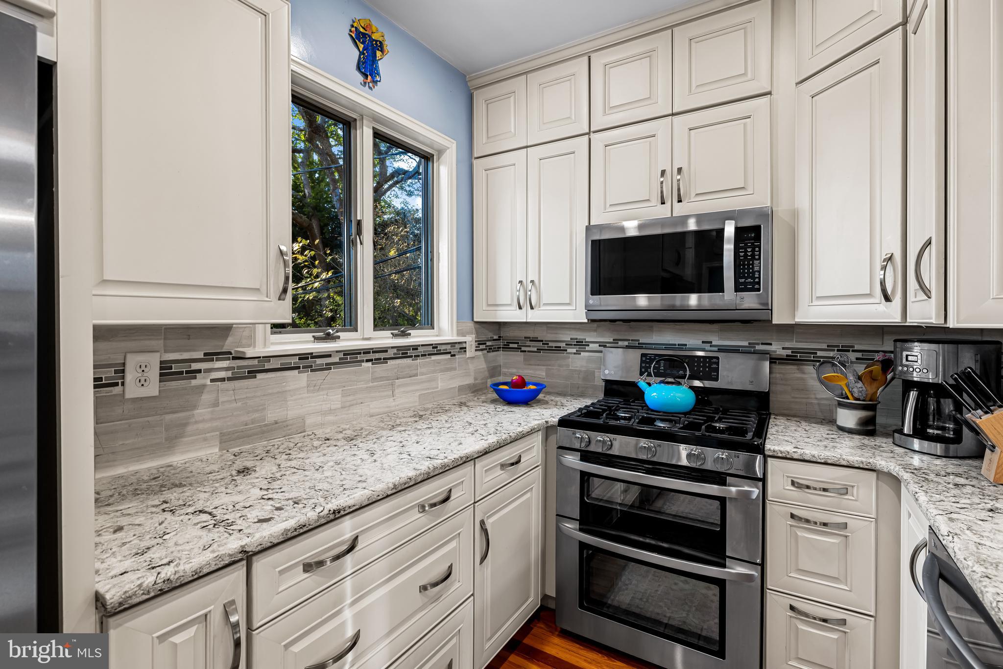529 Overbrook Road Baltimore, MD 21212 - Photo 14 of 40 a kitchen with stainless steel appliances granite countertop a stove a sink and a microwave
