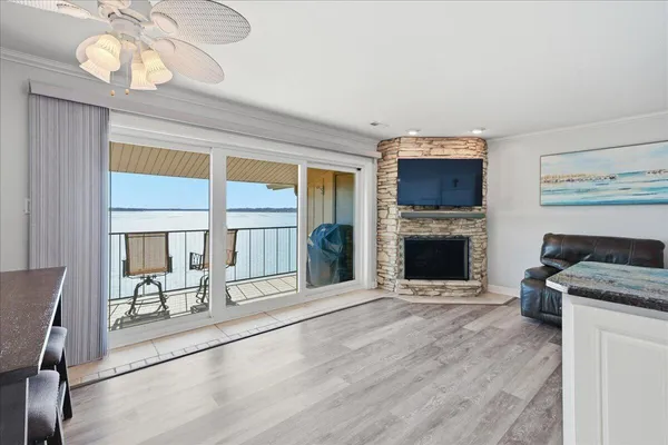 a view of an empty room with a fireplace and a window