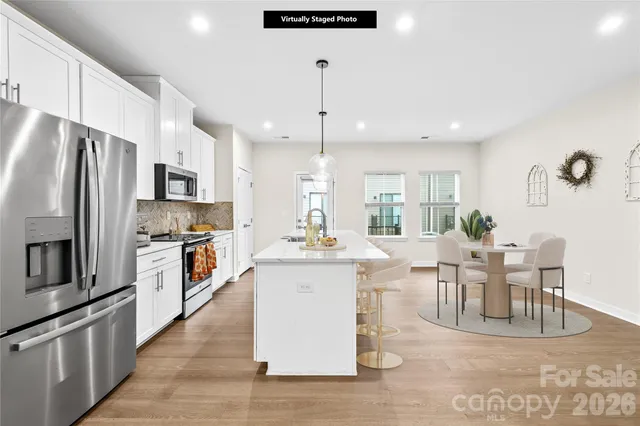 a view of kitchen with sink and refrigerator