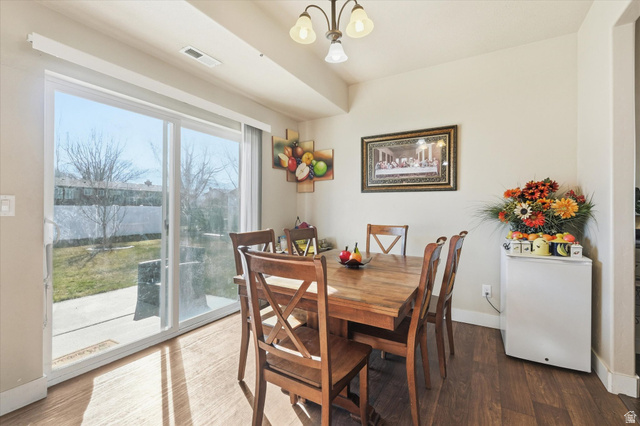 1084 South 740 East Logan, UT 84321 - Photo 6 of 23 Dining area featuring a chandelier and wood finished floors