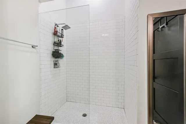 a bathroom with a double vanity sink a mirror and a shower