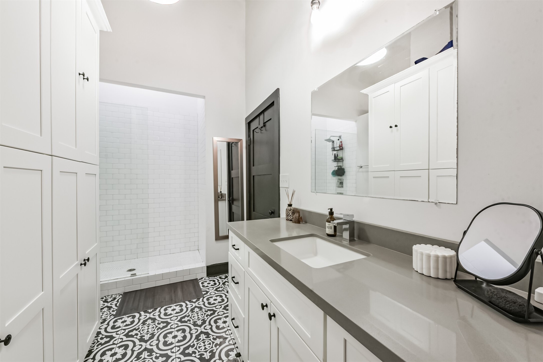 705 Main Street, Unit 321 Houston, TX 77002 - Photo 18 of 39 a bathroom with a double vanity sink a mirror and a shower