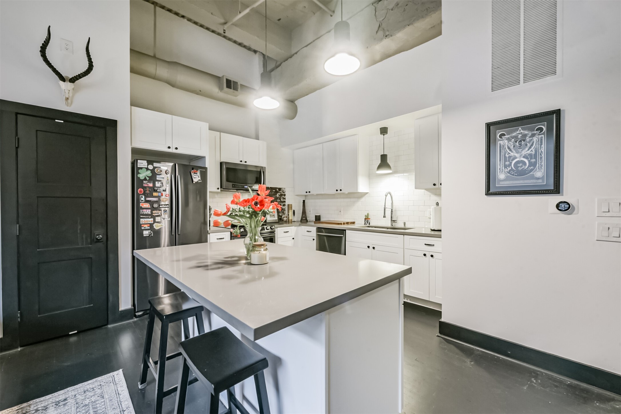 705 Main Street, Unit 321 Houston, TX 77002 - Photo 23 of 39 a kitchen with a table and white cabinets