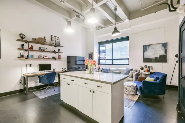 a kitchen with stainless steel appliances a stove a microwave and a sink