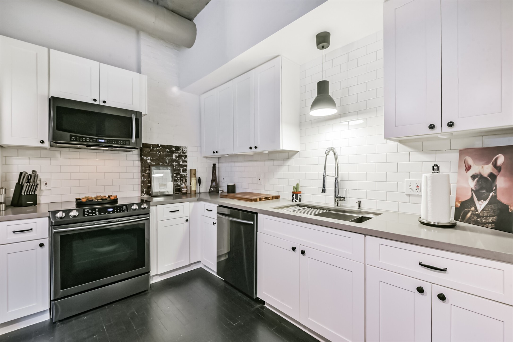 705 Main Street, Unit 321 Houston, TX 77002 - Photo 26 of 39 a kitchen with cabinets stainless steel appliances a sink a stove and cabinets
