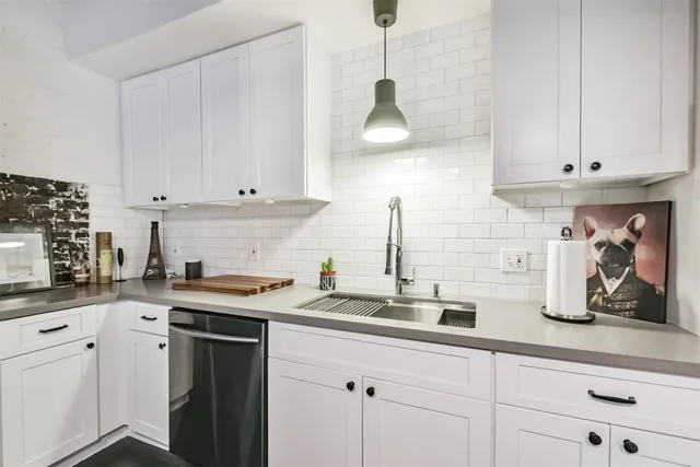 a living room with furniture and a kitchen view