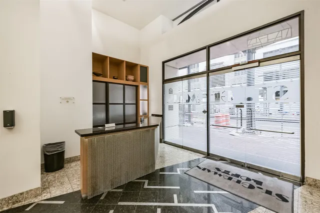 a kitchen with stainless steel appliances granite countertop a refrigerator and a stove