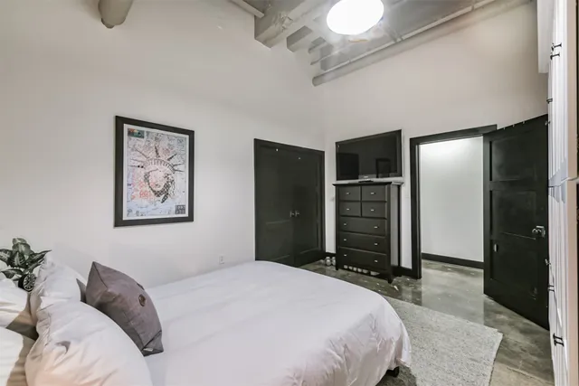 a bedroom with a bed and a television