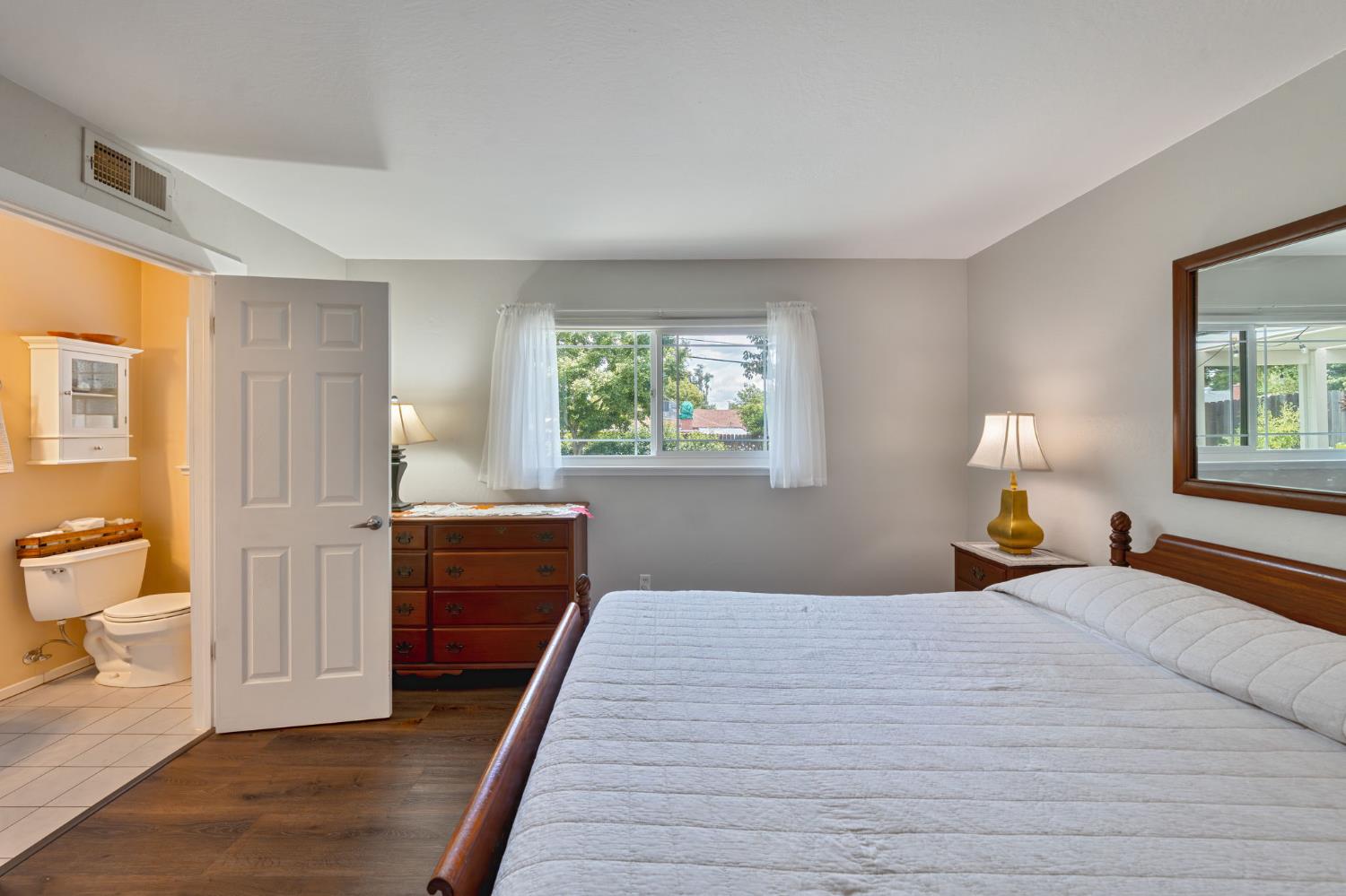 5422 Earnell Street Carmichael, CA 95608 - Photo 22 of 39 a bedroom with a bed and wooden floor