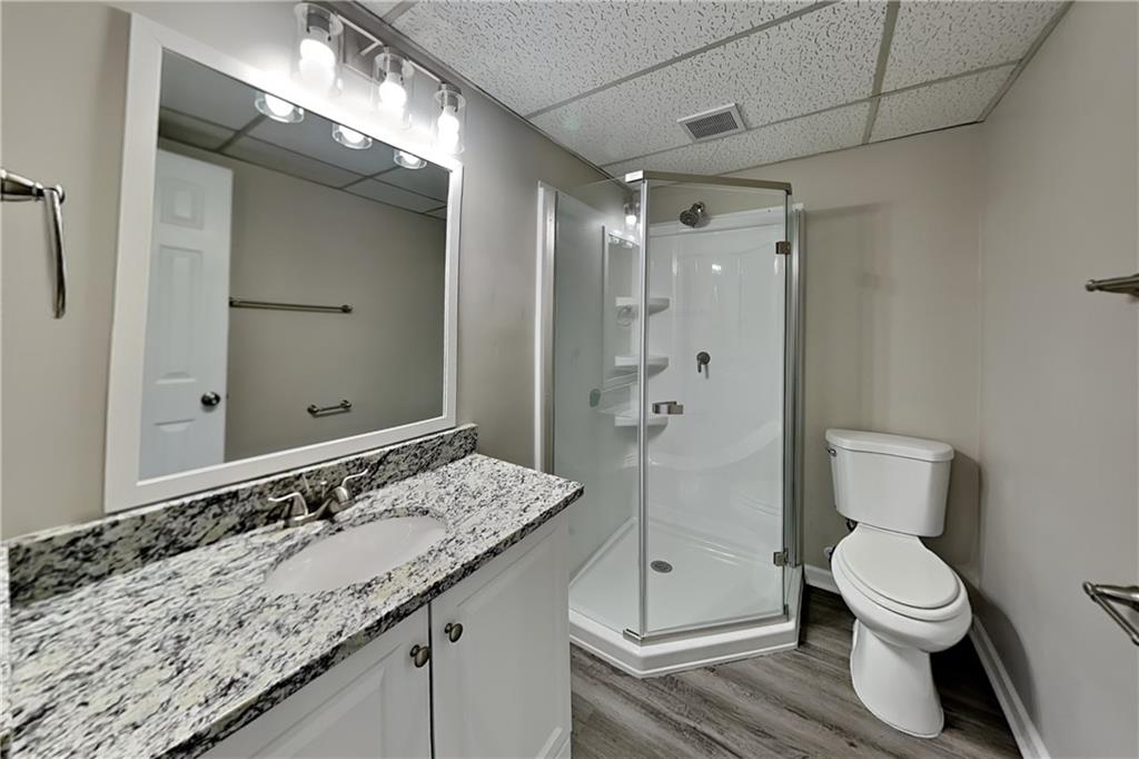 3094 Calumet Circle Northwest Kennesaw, GA 30152 - Photo 15 of 23 a bathroom with a granite countertop sink toilet and shower