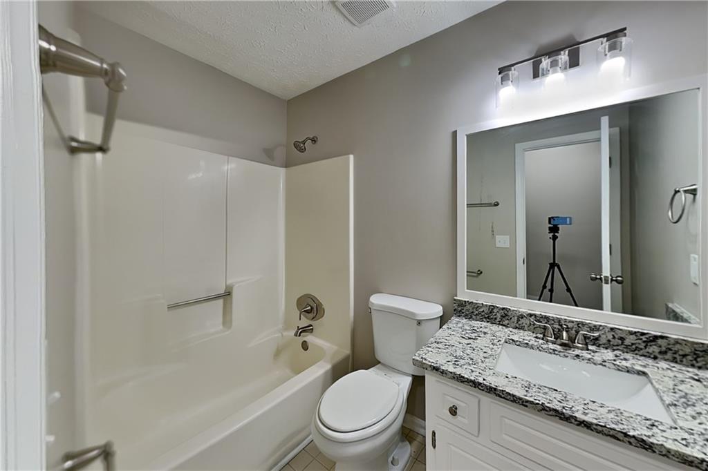 3094 Calumet Circle Northwest Kennesaw, GA 30152 - Photo 16 of 23 a bathroom with a granite countertop sink a toilet and shower