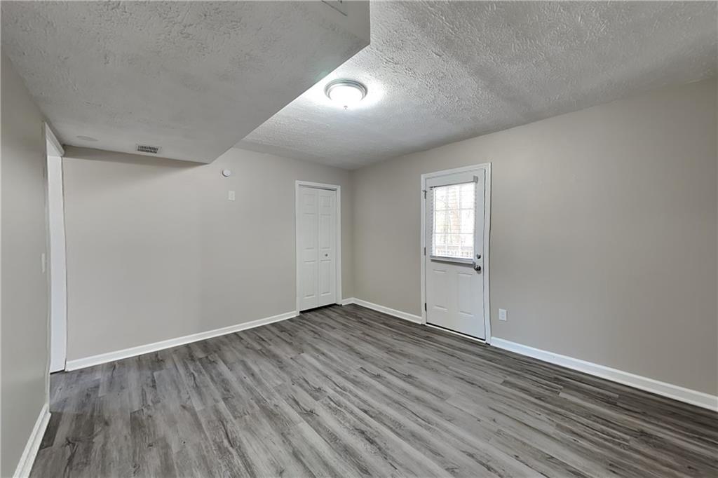 3094 Calumet Circle Northwest Kennesaw, GA 30152 - Photo 17 of 23 an empty room with wooden floor and windows