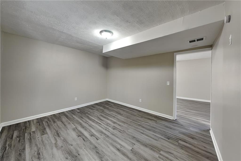 3094 Calumet Circle Northwest Kennesaw, GA 30152 - Photo 18 of 23 a view of an empty room with wooden floor