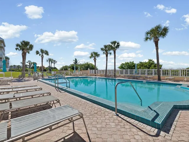 a swimming pool with outdoor seating and yard