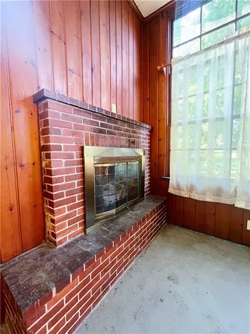 a living room with a fireplace and a window