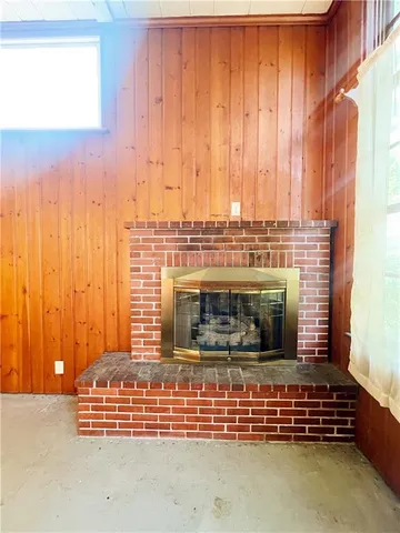 a view of water heater room with a fireplace
