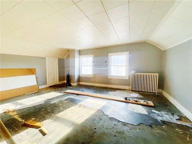 a bedroom with a bed and a mirror