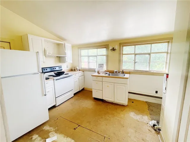 a view of a room with wooden floor