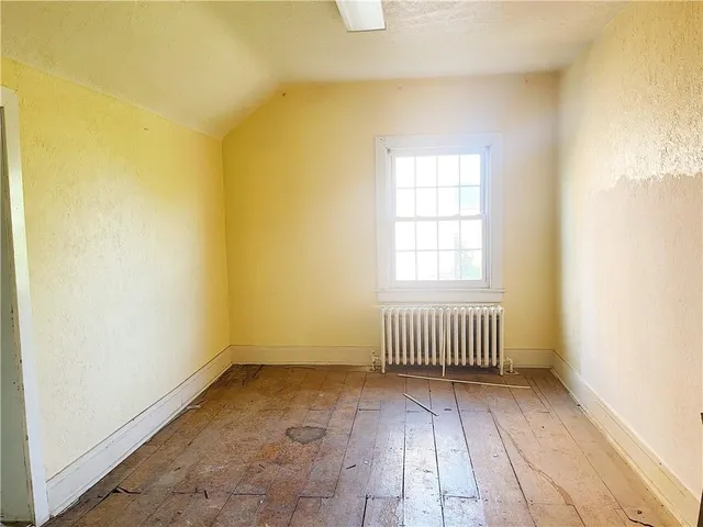 a view of a kitchen with kitchen island sink and refrigerator