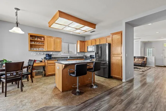 a view of kitchen with refrigerator and furniture