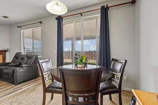 a dining room with furniture and window