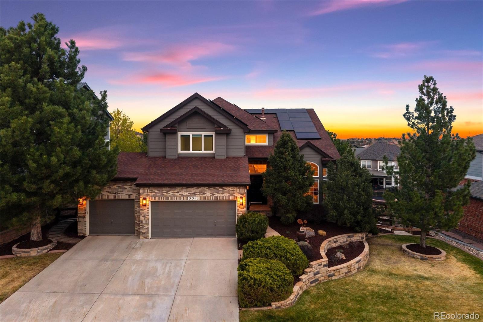 551 Seth Place Castle Pines, CO 80108 - Photo 1 of 50 a front view of a house with a yard and garage