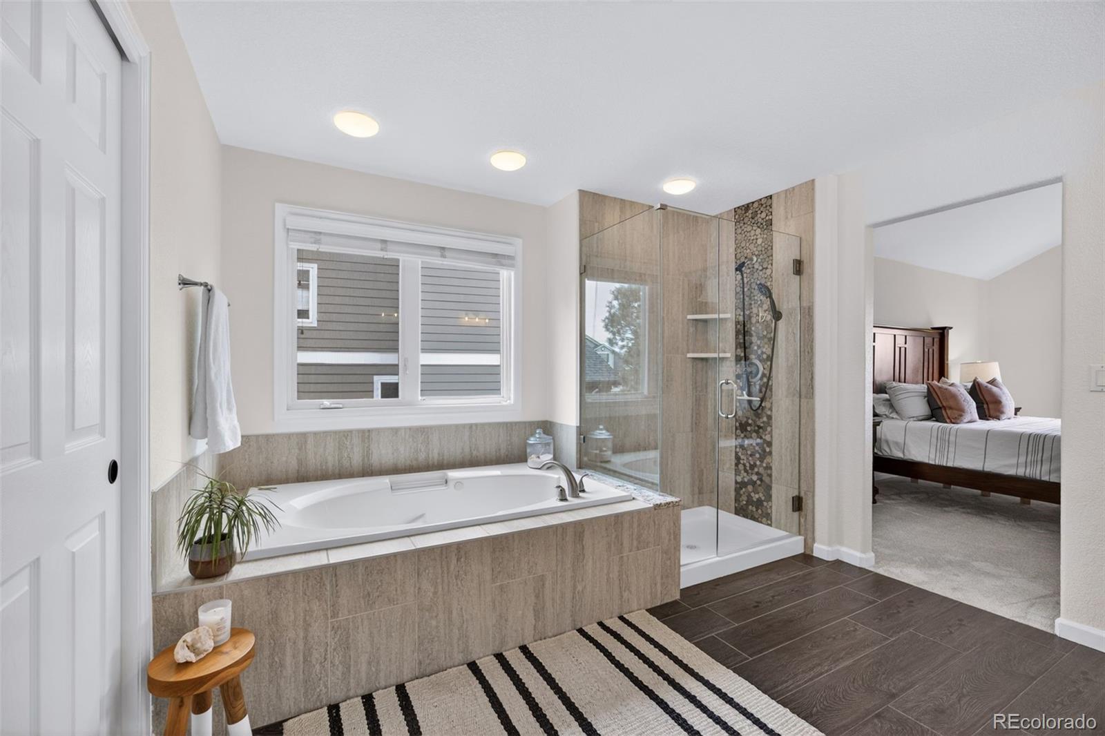 551 Seth Place Castle Pines, CO 80108 - Photo 26 of 50 a spacious bathroom with a tub and shower
