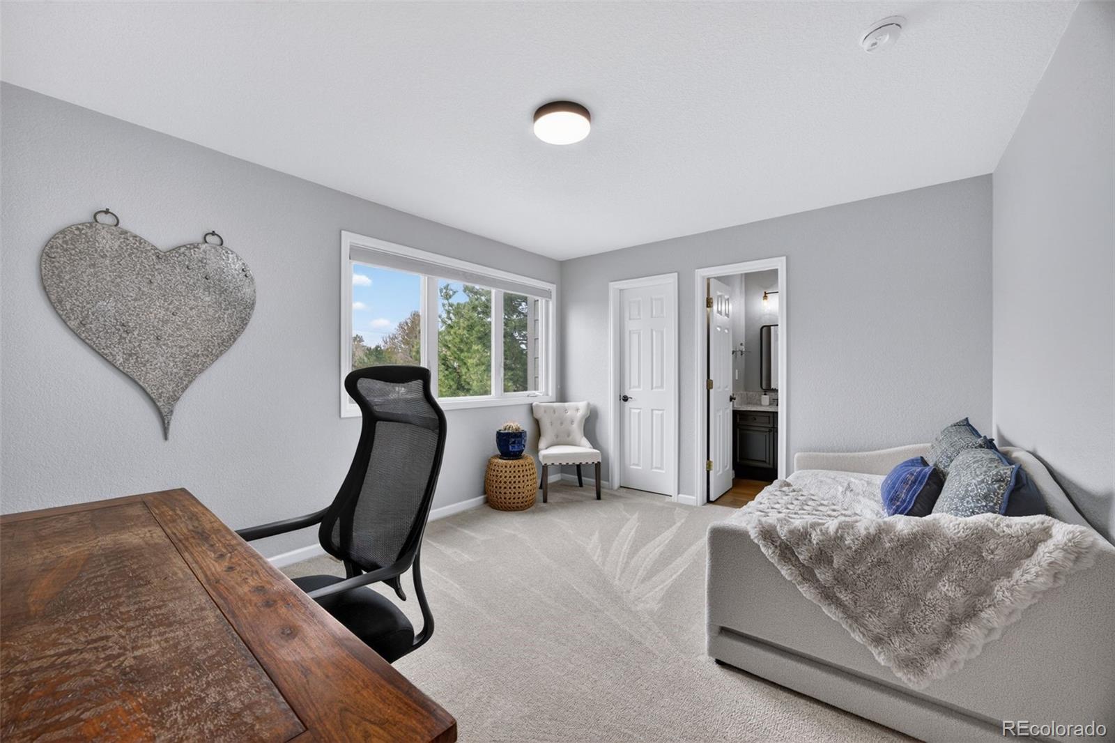 551 Seth Place Castle Pines, CO 80108 - Photo 27 of 50 a bedroom with furniture and a window