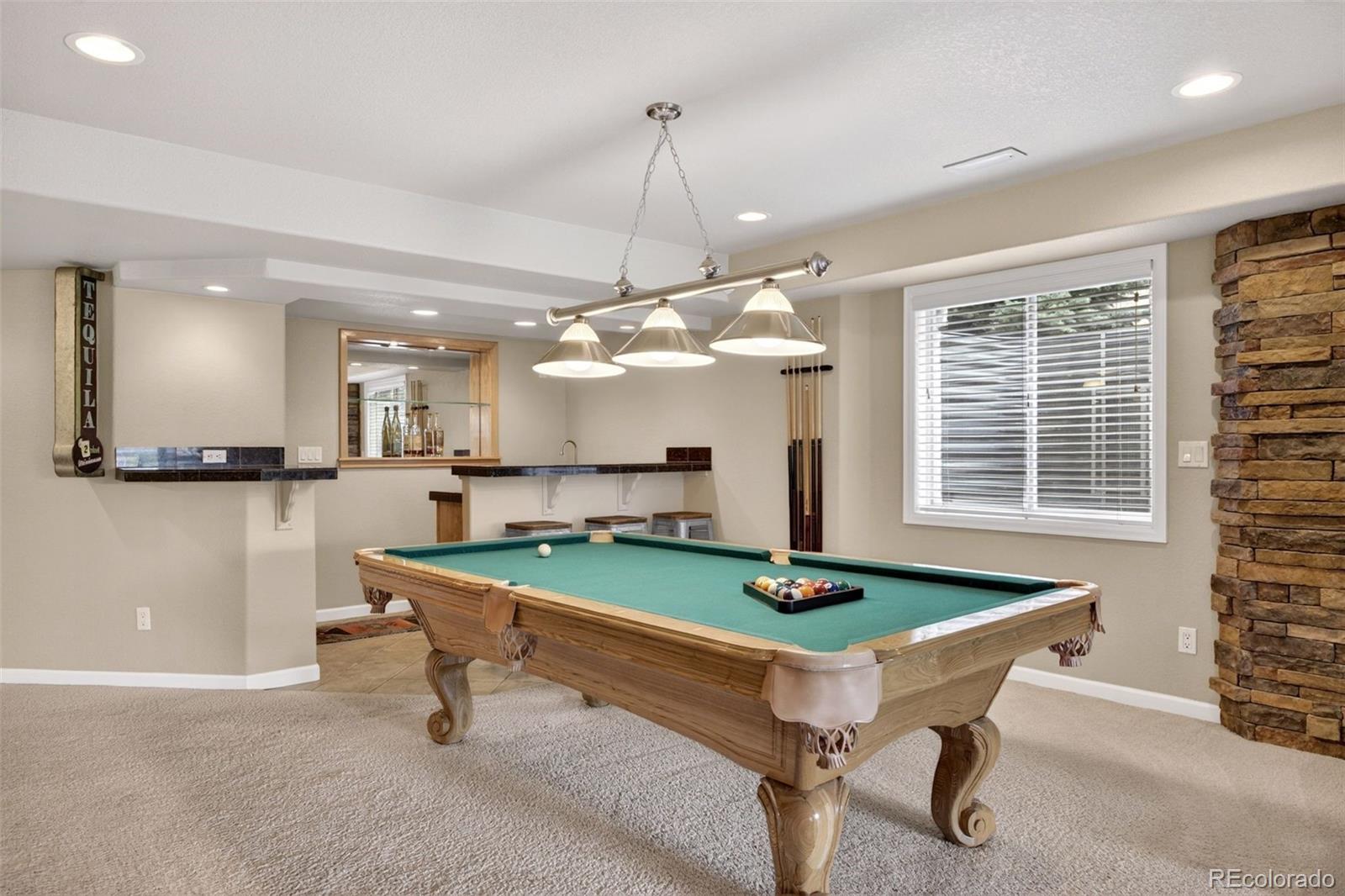 551 Seth Place Castle Pines, CO 80108 - Photo 33 of 50 a room with pool table and windows
